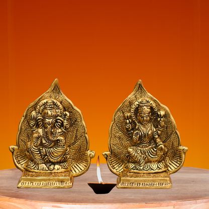 Lord Ganesh And Maa Laxmi Seat On Leaf